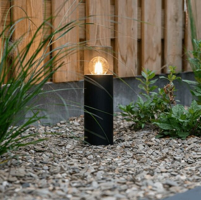 Black Lamp Illuminates Stone Garden